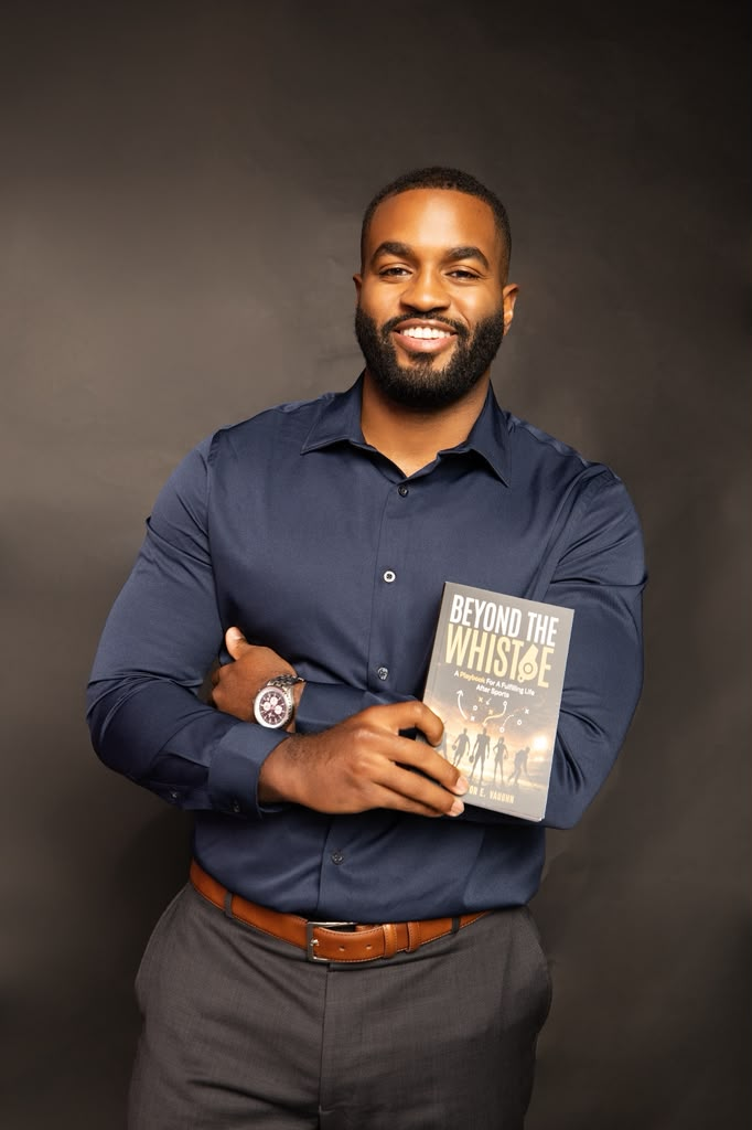 Carrington E. Vaughn holding Beyond the Whistle